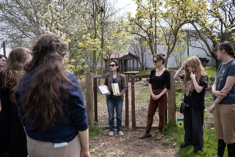 English Dept Chair Dr. Courtney Rydel holds class in the new campus Poetry Garden. 