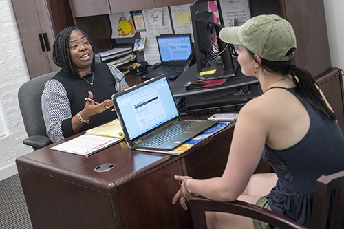 a student talks with a career counselor at her desk