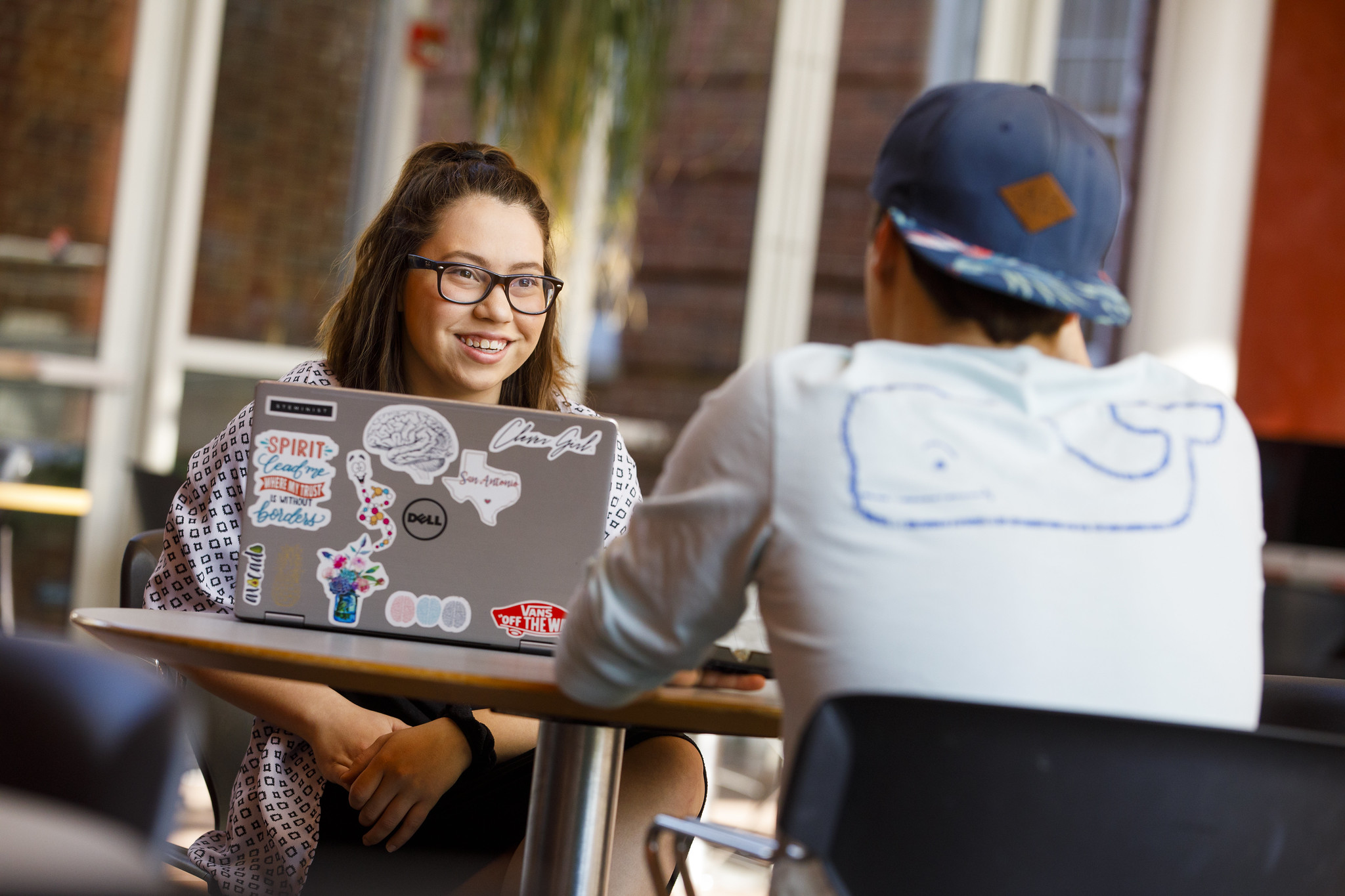 Students Talking at a table with computer in front of them