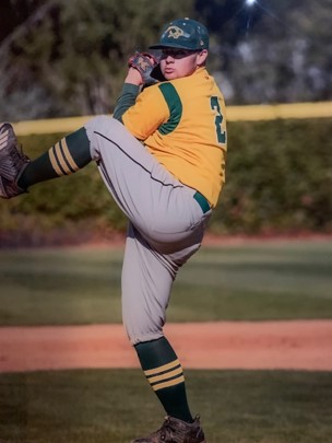 Vincent Bawden pitching a baseball with his right leg up