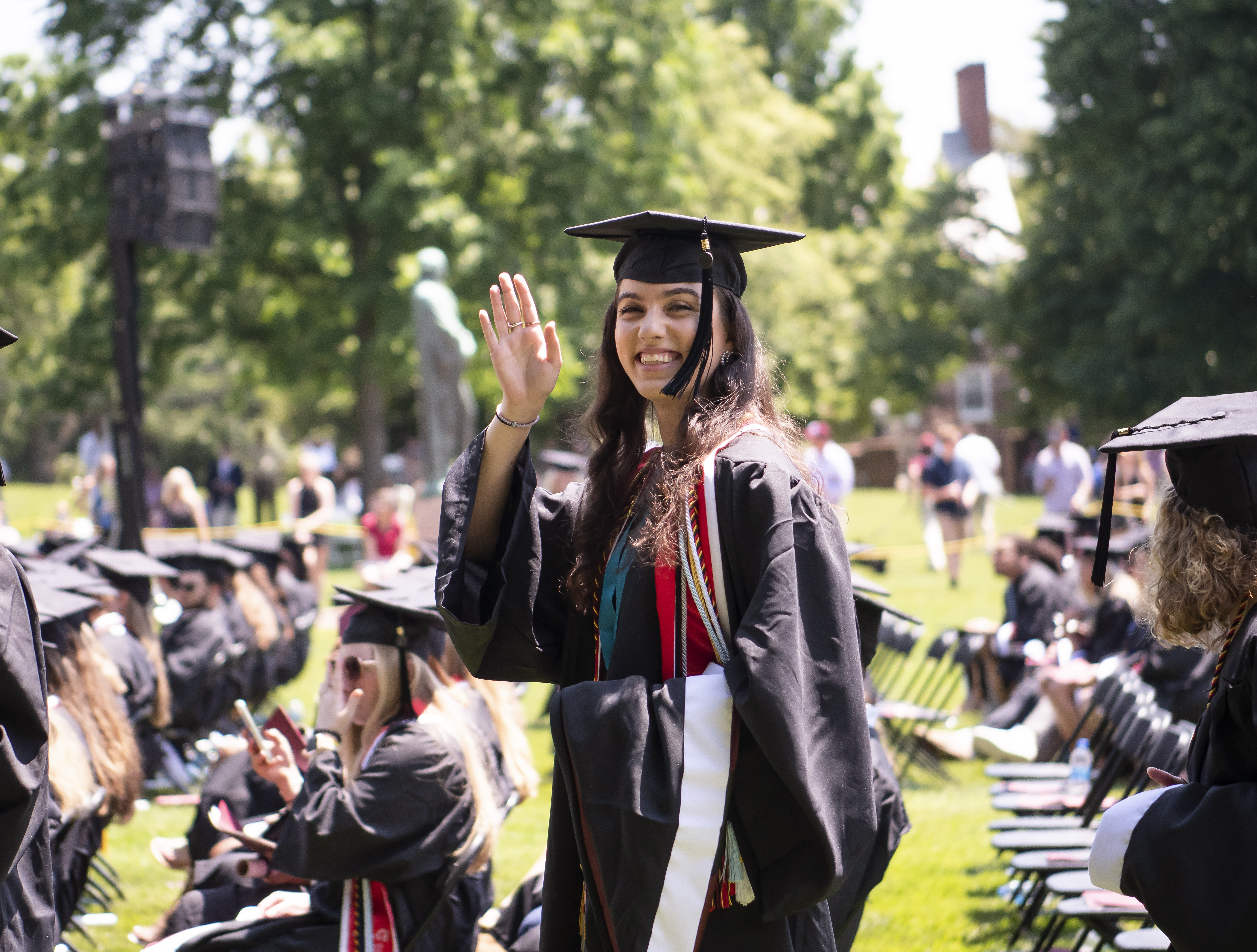 Washington College Graduate smiling and waving