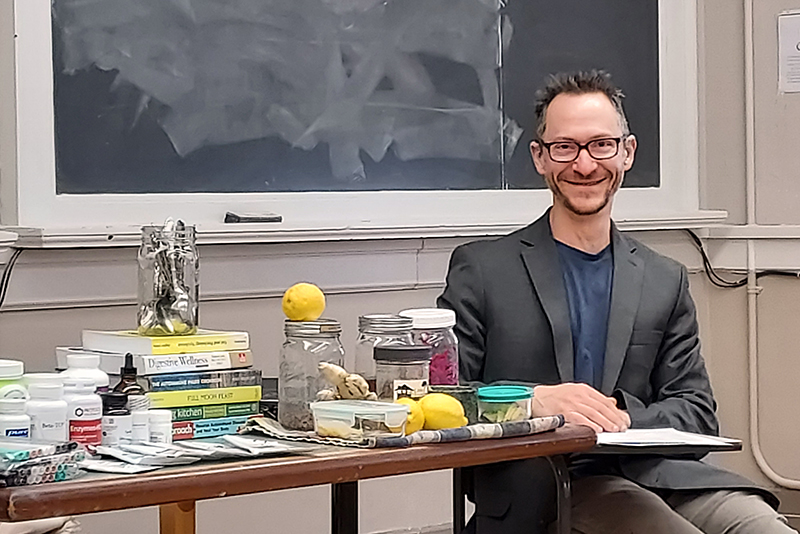 Shane Brill sits at the front of a classroom with a collection of resources for a class he was teaching at the Washington College Academy of Lifelong Learning.