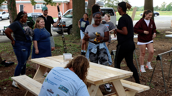 Students and staff at Minary's Dream Alliance build picnic tables