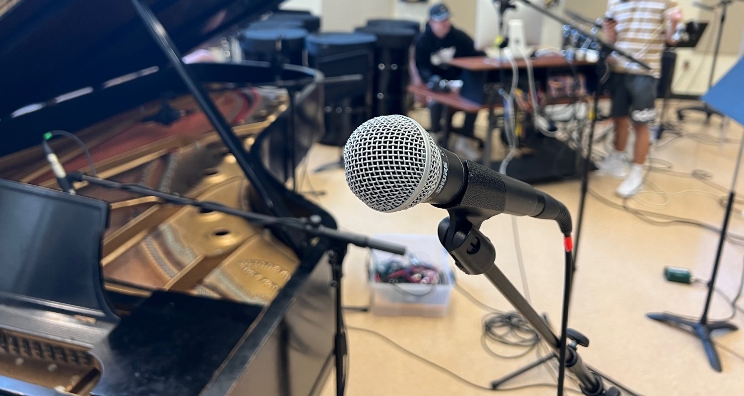 a microphone in focus with blurred studio background