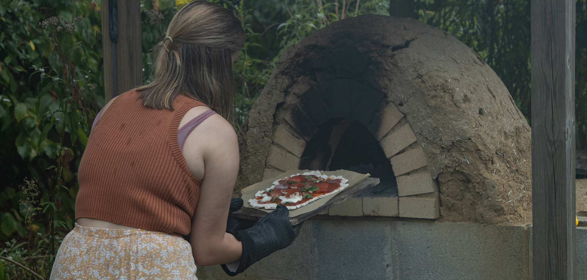 student using a pizza oven