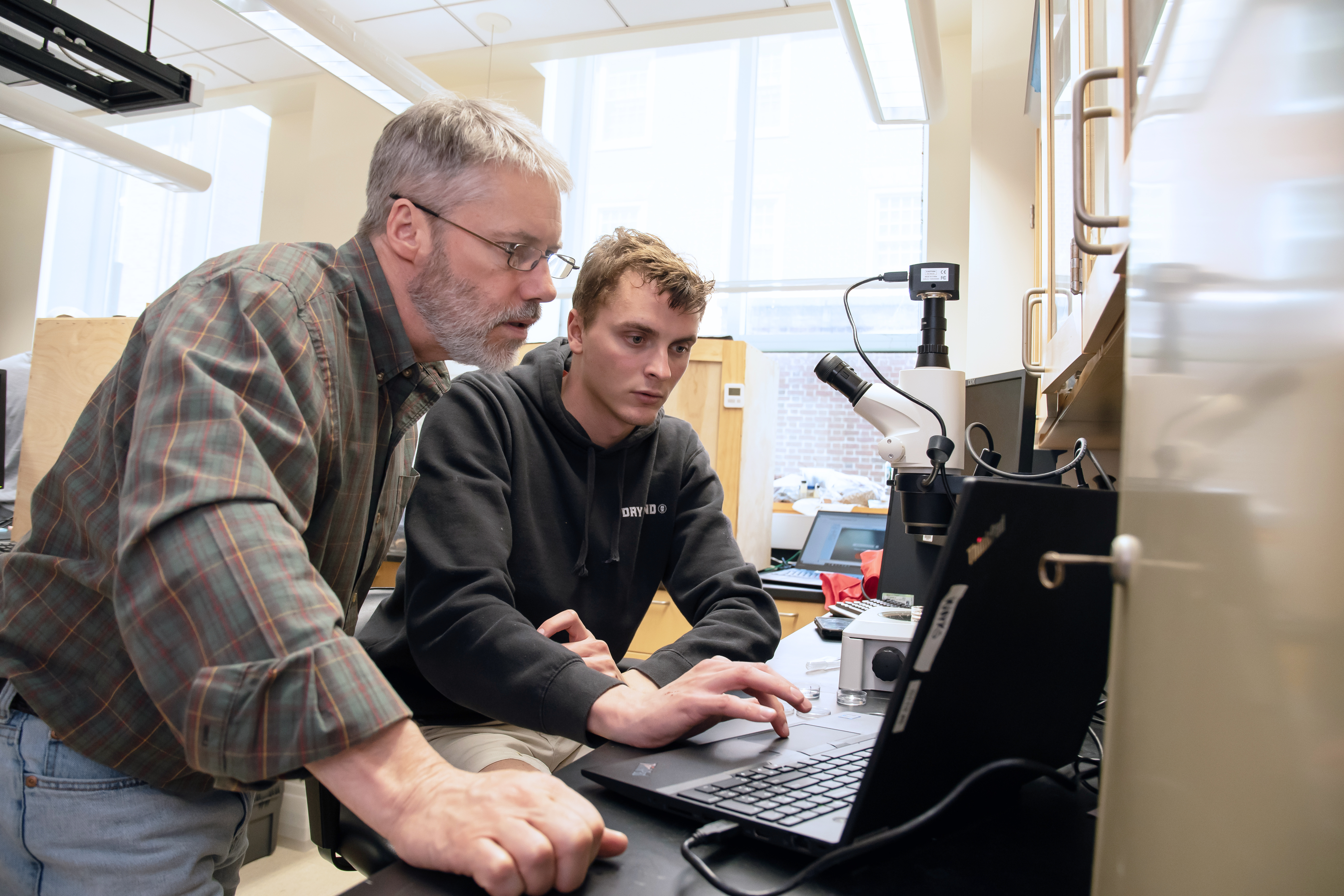 Student and Professor working at computer