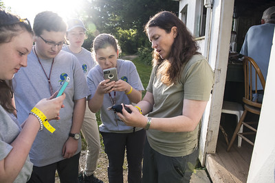 students taking pictures of caught bird at foreman's branch bird observatory