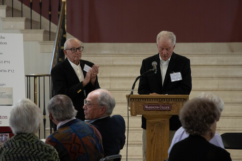 man speaking at podium 