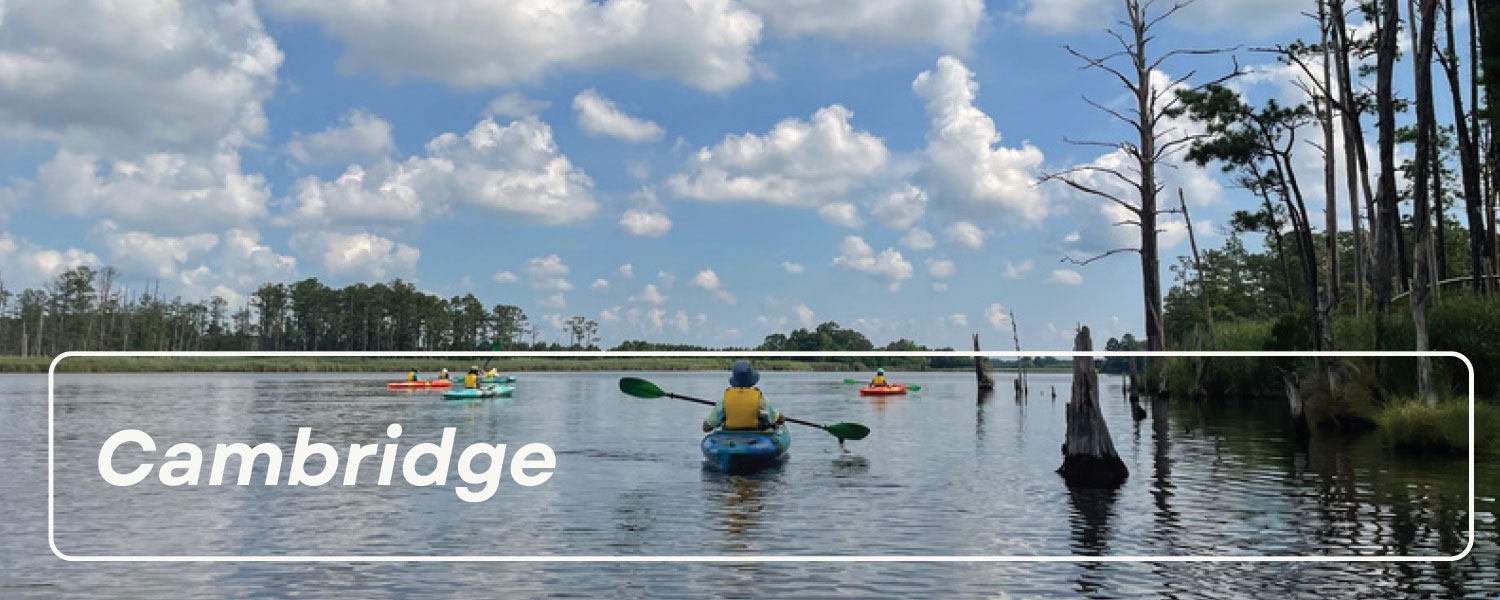 People kayaking on river with text Camridge