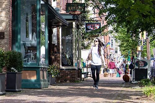 a woman walks past an art gallery in Chestertown