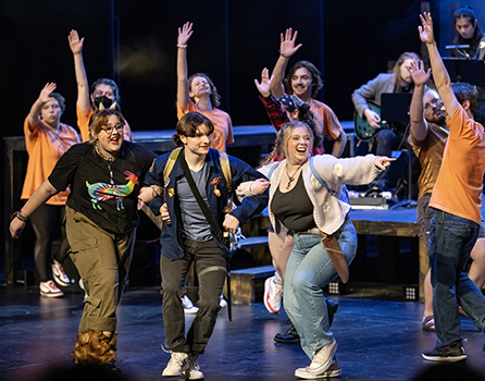 students perform on stage