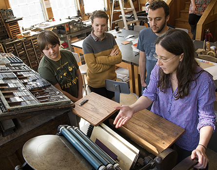 students examine a printing press
