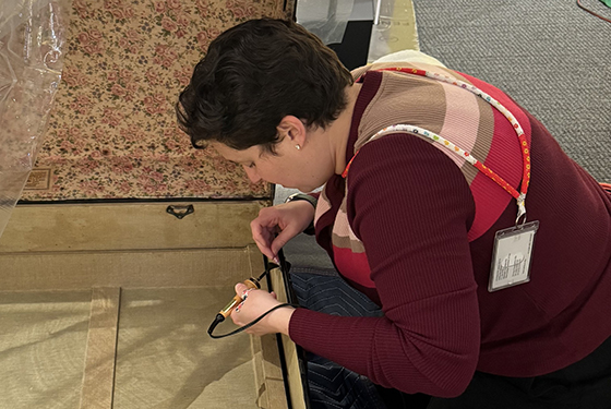 Rebecca Byeth working on an antique chest