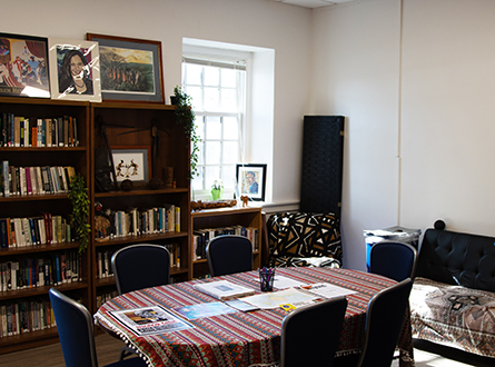 Room with bookshelves, conference table and a sofa