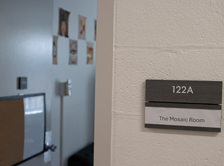 open door next to room sign reading "Mosaic Room"