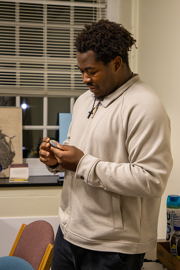 a student looks at the rock he painted during an event at the Intercultural Center