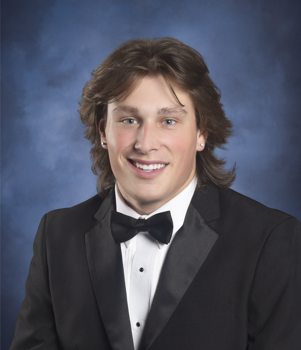 student in highschool tux graduation photo