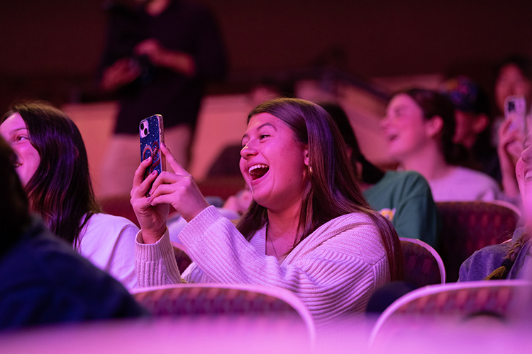 student having fun watching big man