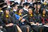 Students laugh in their seats at commencement. [photo]
