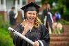 A graduate waves after receiving her diploma. [photo]
