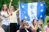 Students cheer while holding up a Phi Delta Theta flag at commencement. [photo]