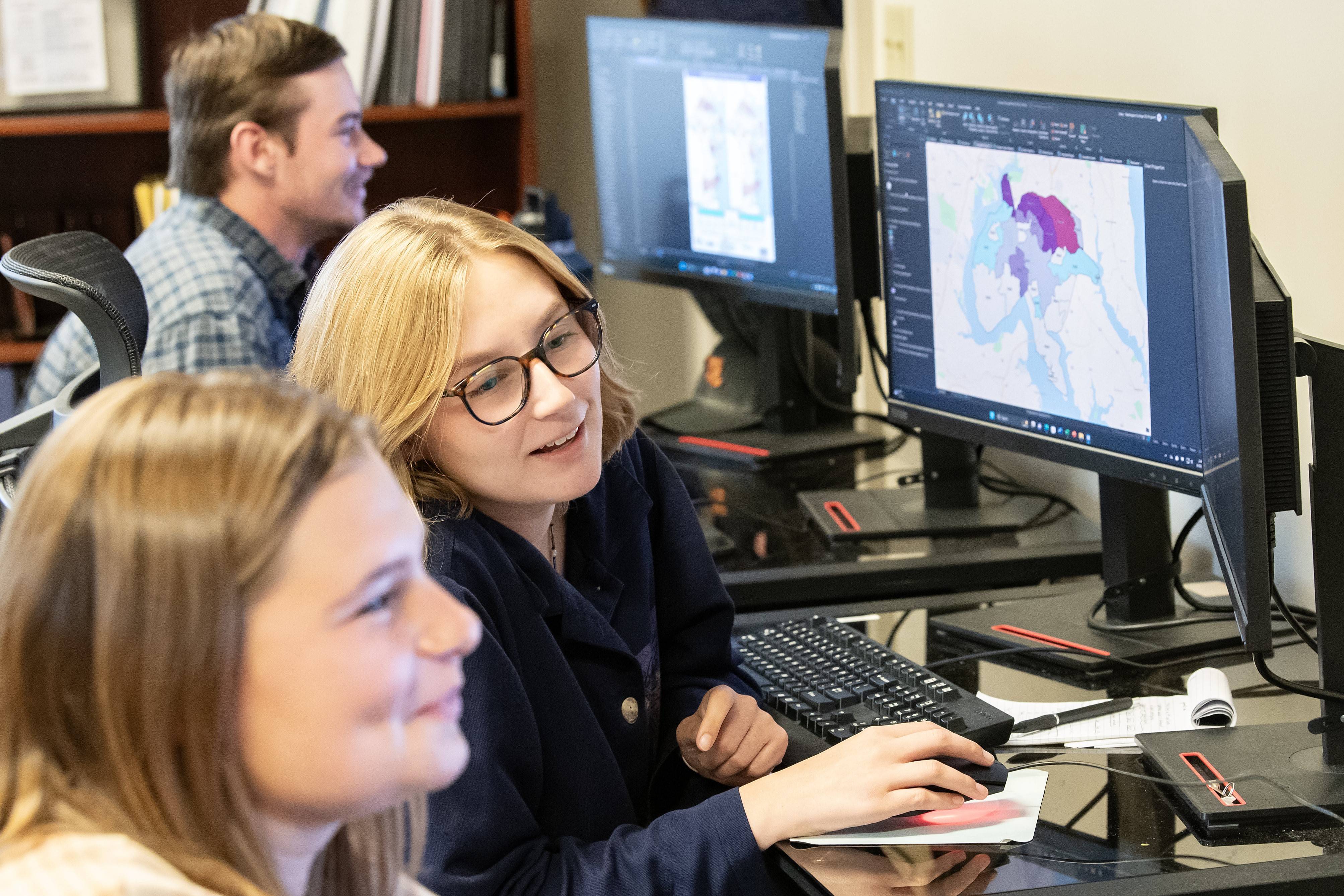 Students looking at GIS data on a computer