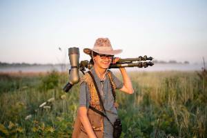 Person with large camera in wetlands