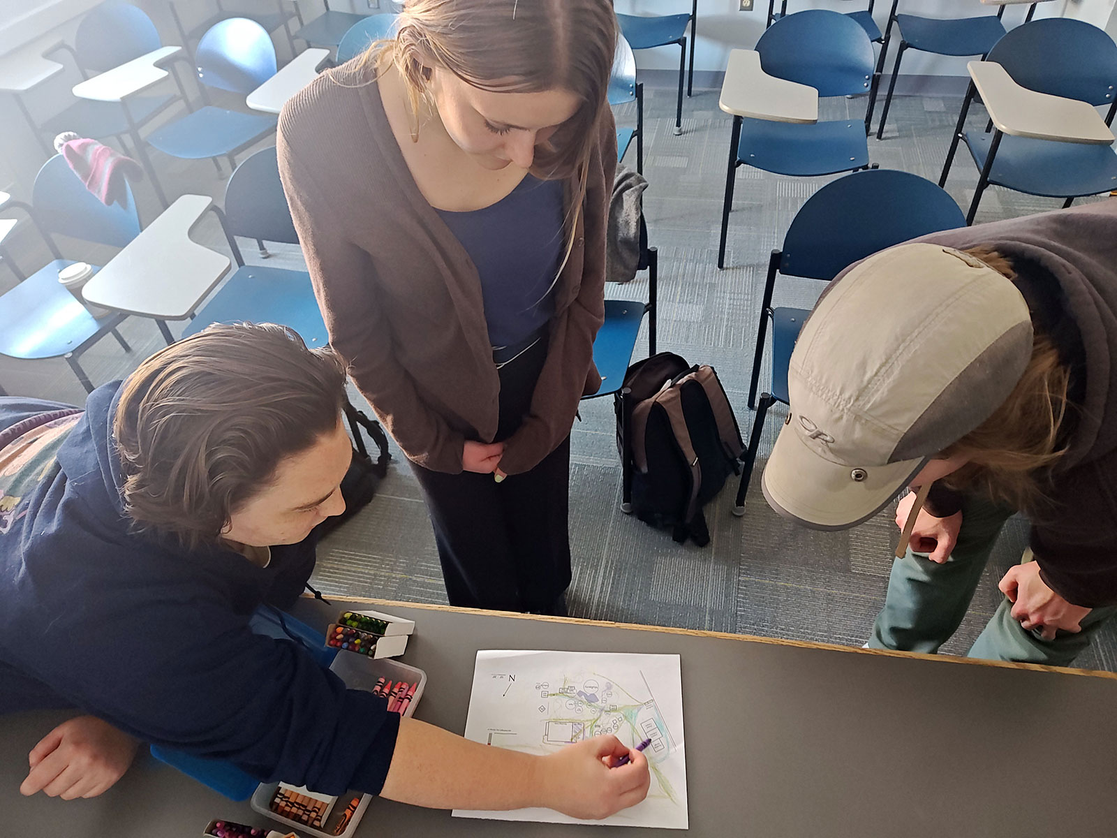 Students looking at sketch of garden