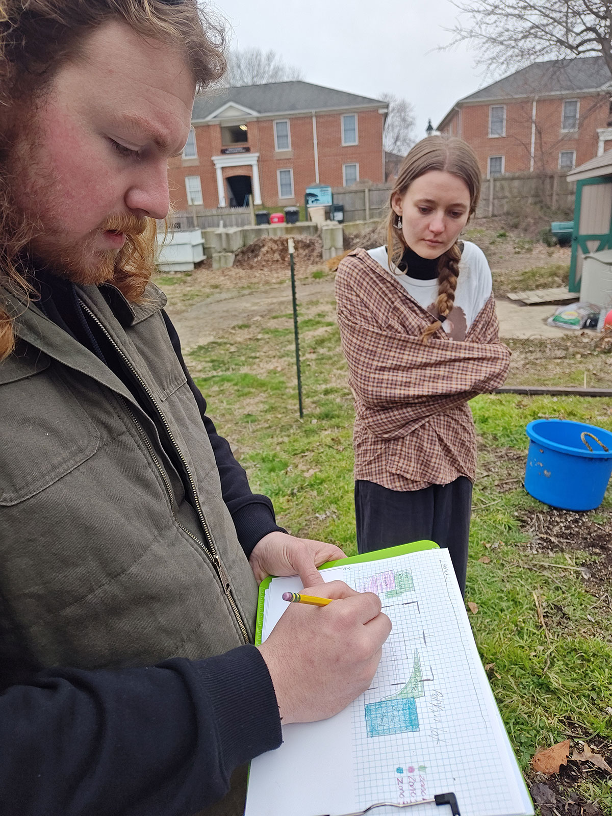 students looking at garden plan