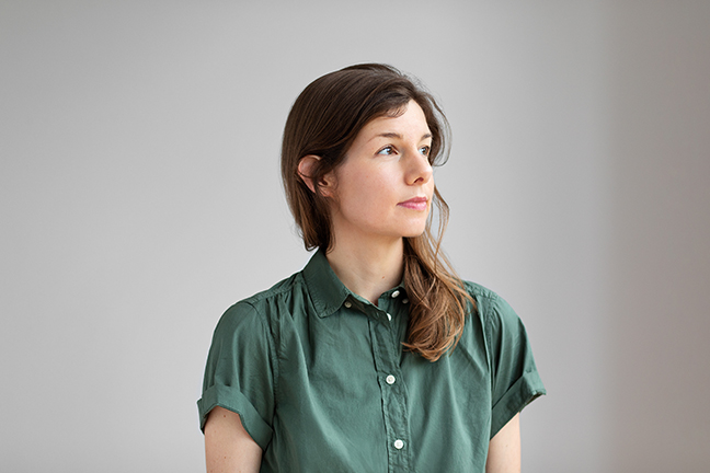 Photo of author Allegra Hyde wearing a moss green, short-sleeve collared shirt looking off to the right of frame