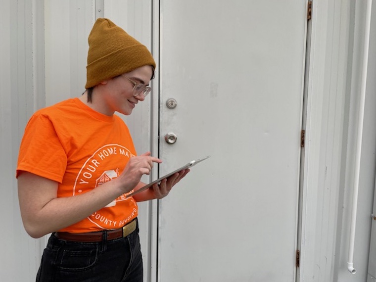 C.Townsend, a Washington College student, reviews a research sheet as part of the Kent County Housing Survey project in partnership with Rebuilding Together Kent County.