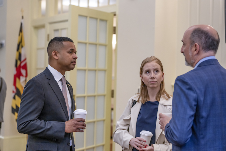Sec. Monteiro and a staff member listen to Adam Goodheart, director of the Washington College Starr Center for the Study of the American Experience