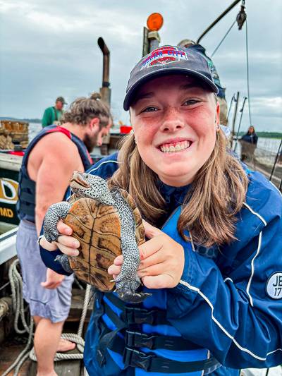 Anna McCabe holds up a terrrapin