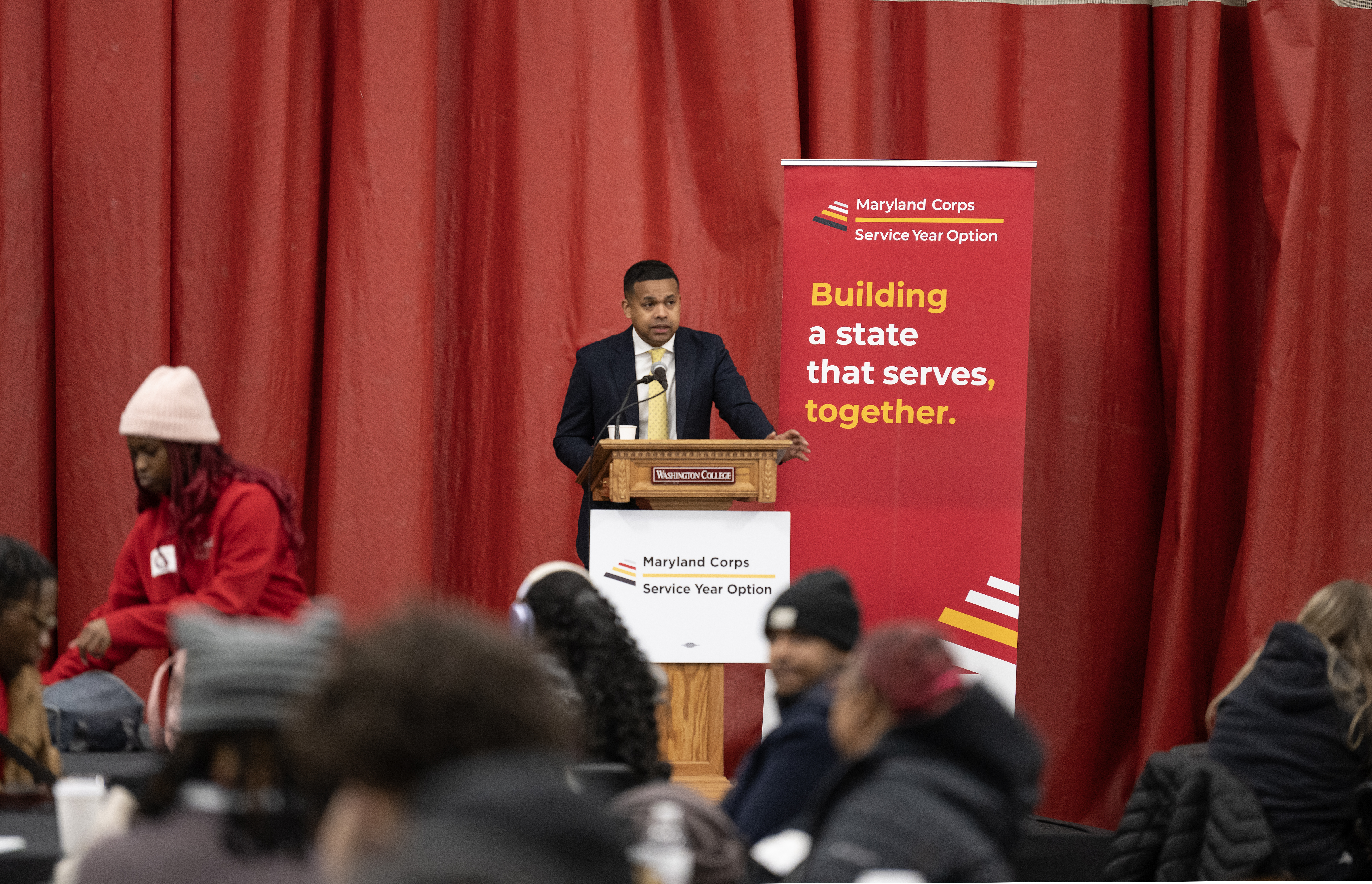 Maryland Department of Service and Civic Innovation (DSCI) Secretary Paul Monteiro, Jr., addresses over 450 conference attendees at the first All Corps event for the current class of Maryland Corps, Service Year Option, and AmeriCorps Members at Washington College. 