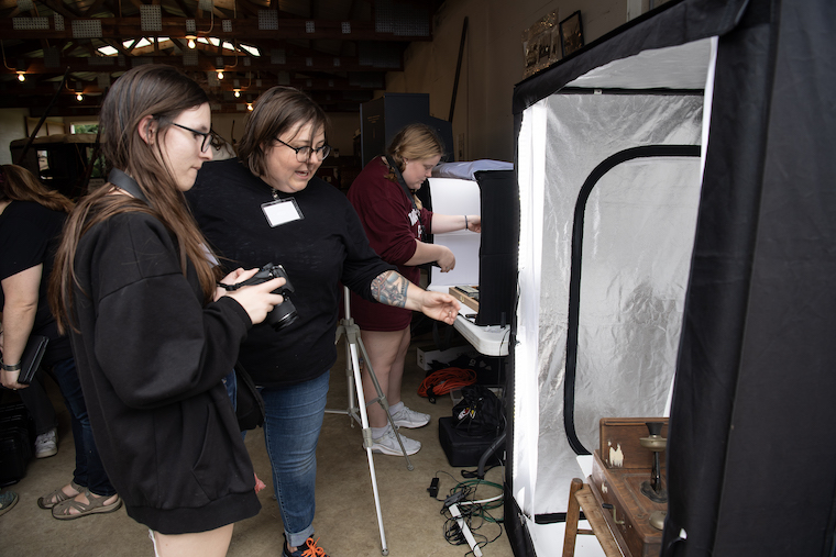 Washington College Professor Sara Clarke - De Reza helps students participating in the Digital Scholarship in Museum Partnership project at the Kent Museum. 