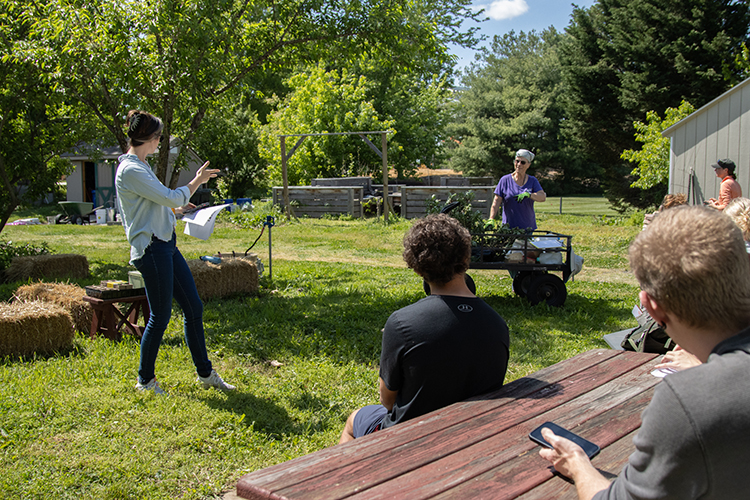 nikki hurless leads students in the campus garden during the last class of ecotherapy