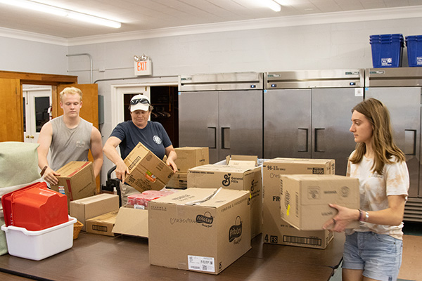 Students and a staff member deliver donations to the Kent County Food Pantry