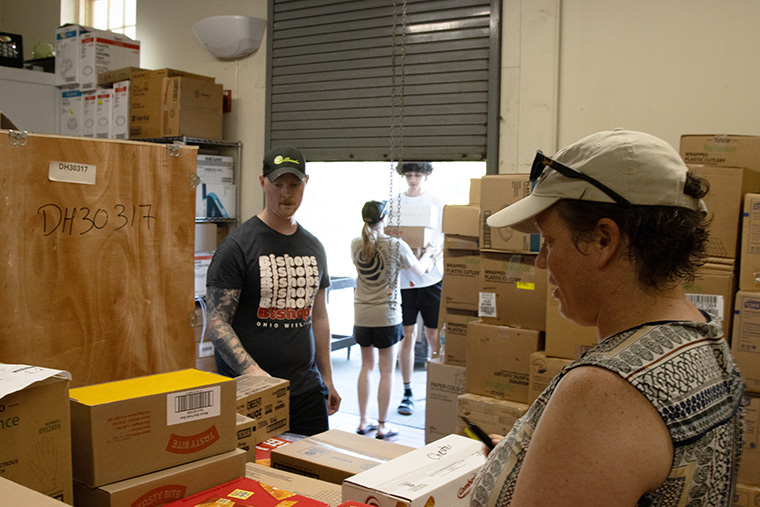 Students and staff at Washington College sort the food donations purchased with student donations for local food pantries.