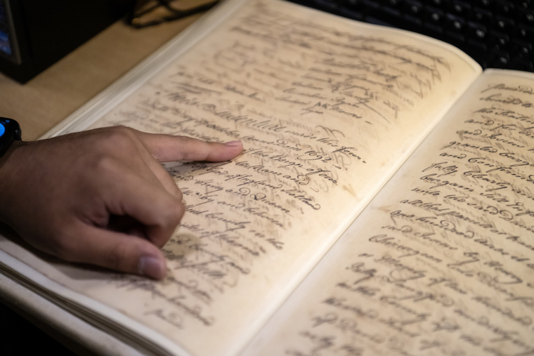 Washington College student Felipe Tassara explores texts in the Maryland State Archives as part of his Explore America internship.