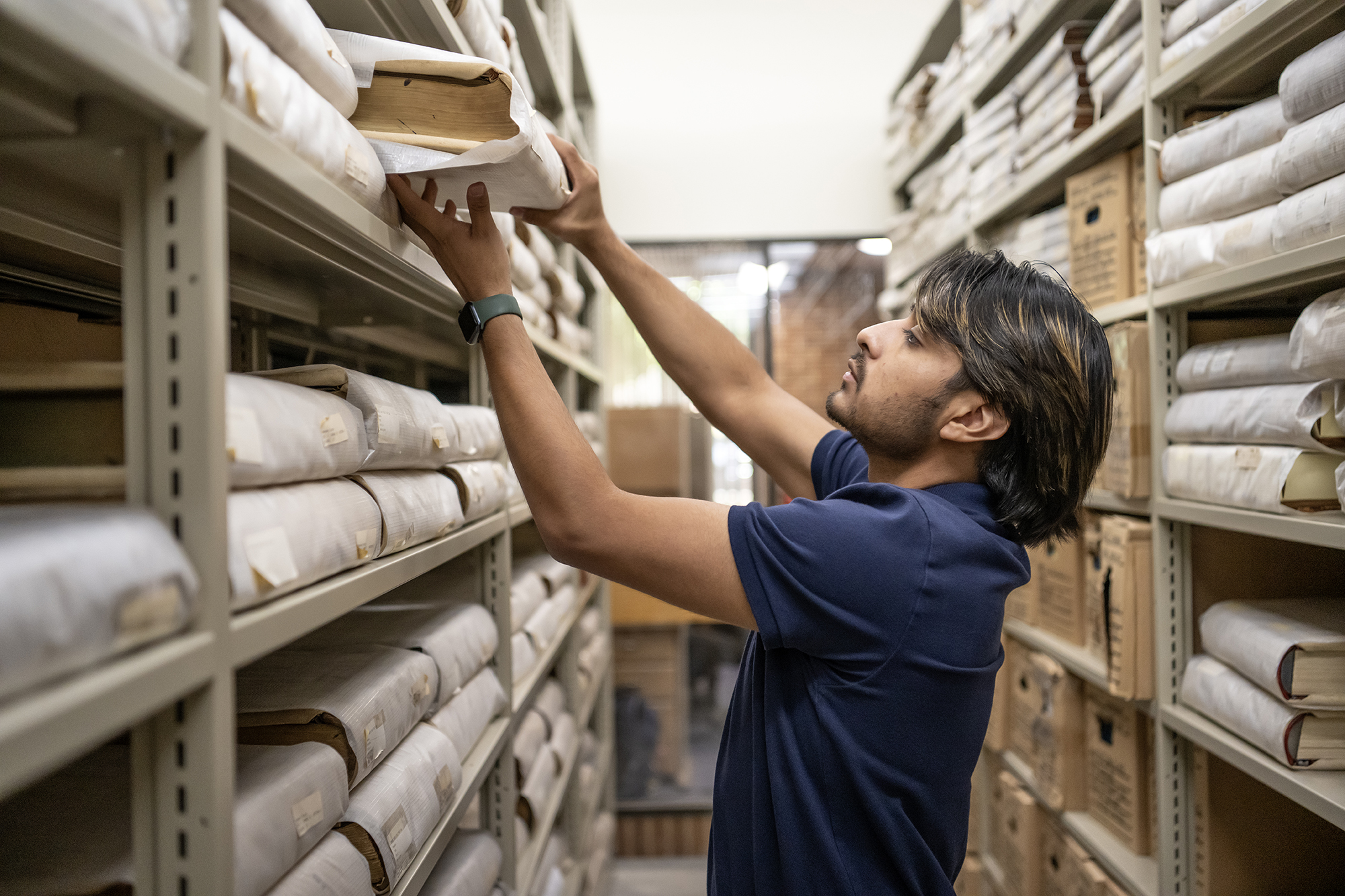 student pulling books in the maryland state archive