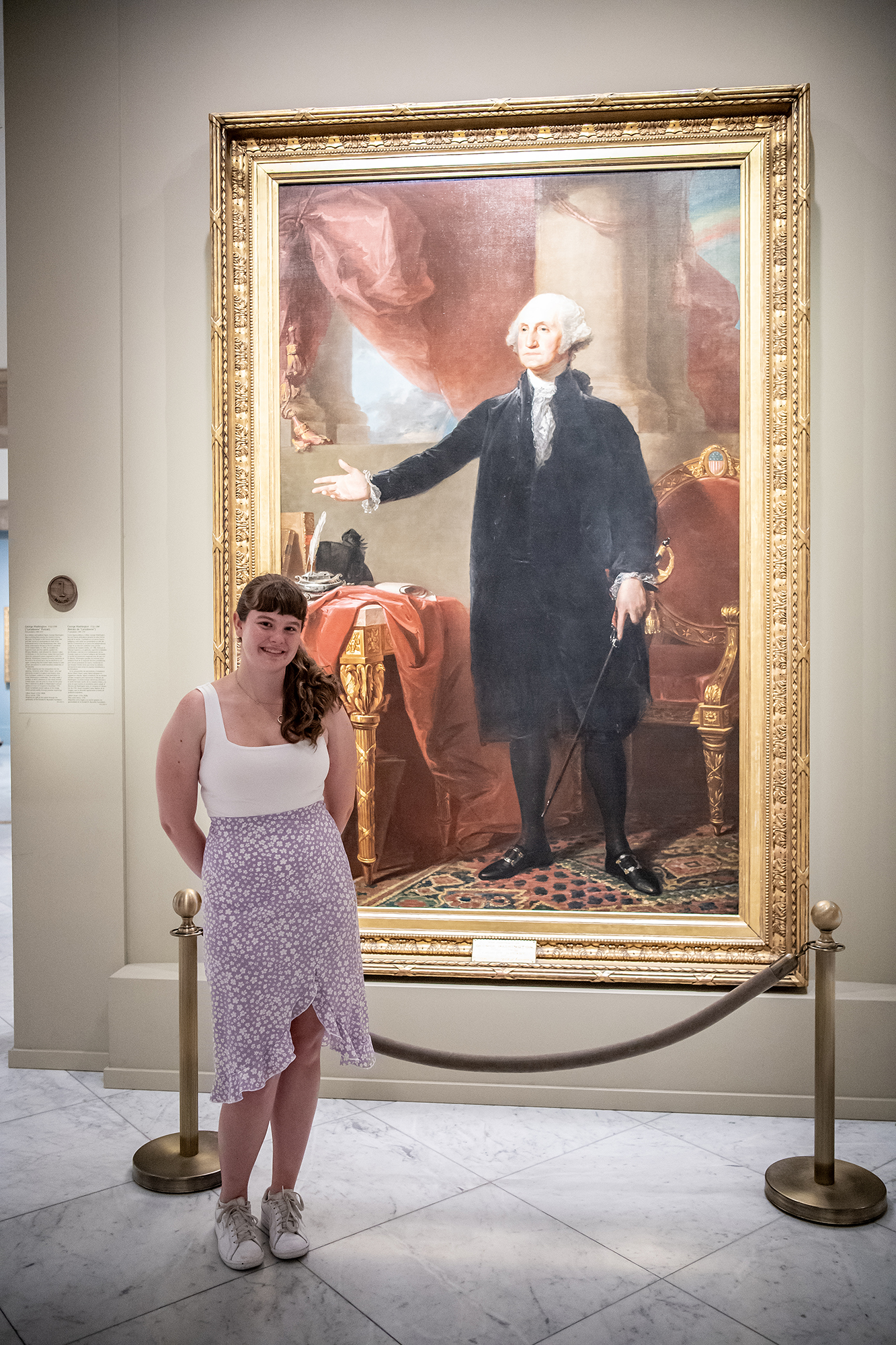 student intern with painting of george washington
