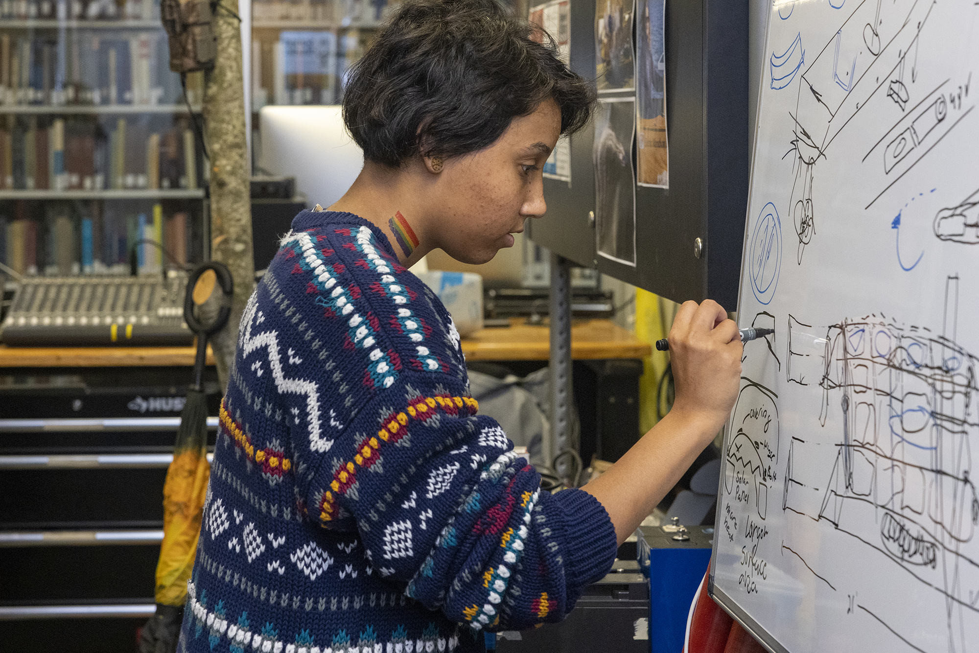 student writing on white board