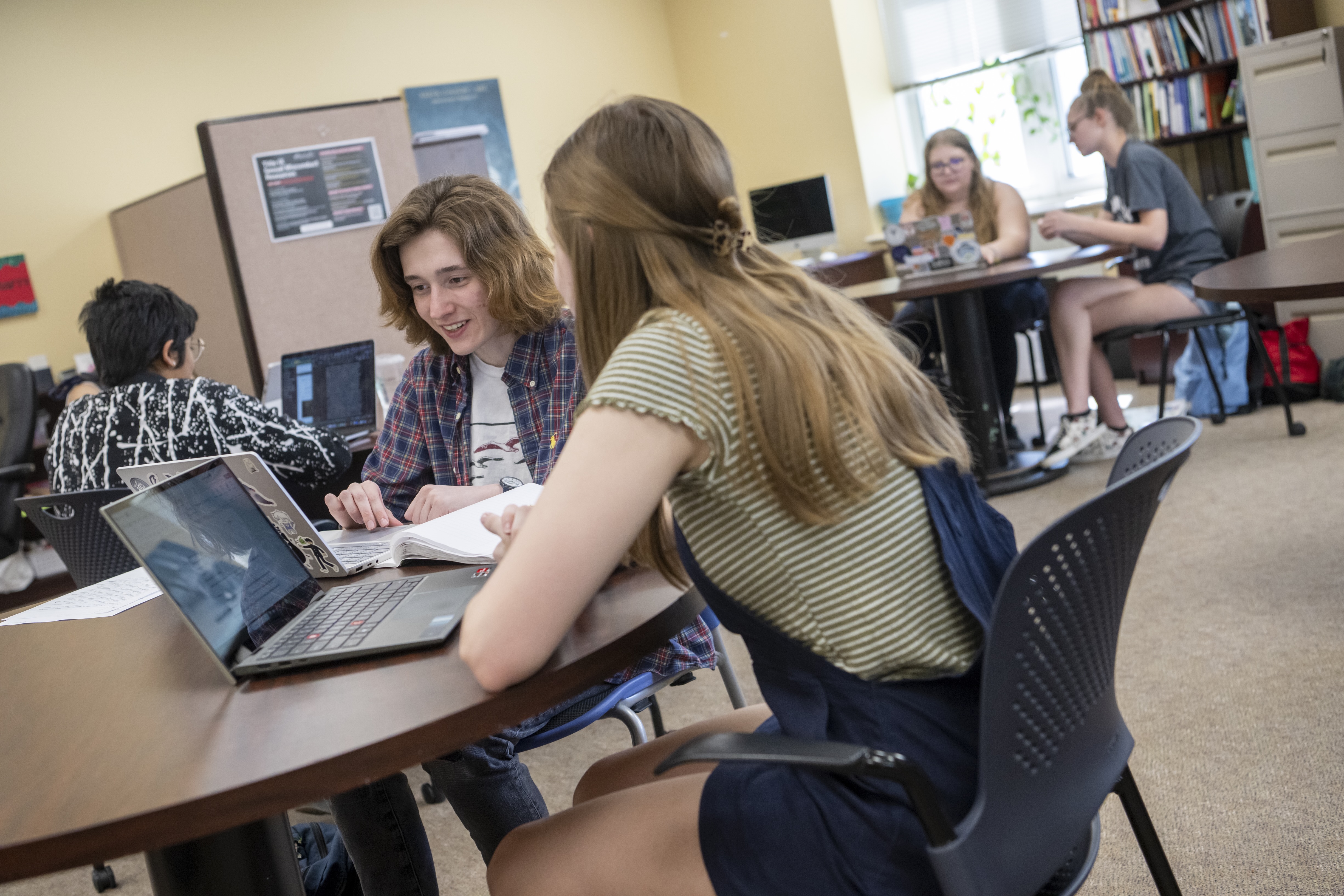 Two people sitting in the writing center