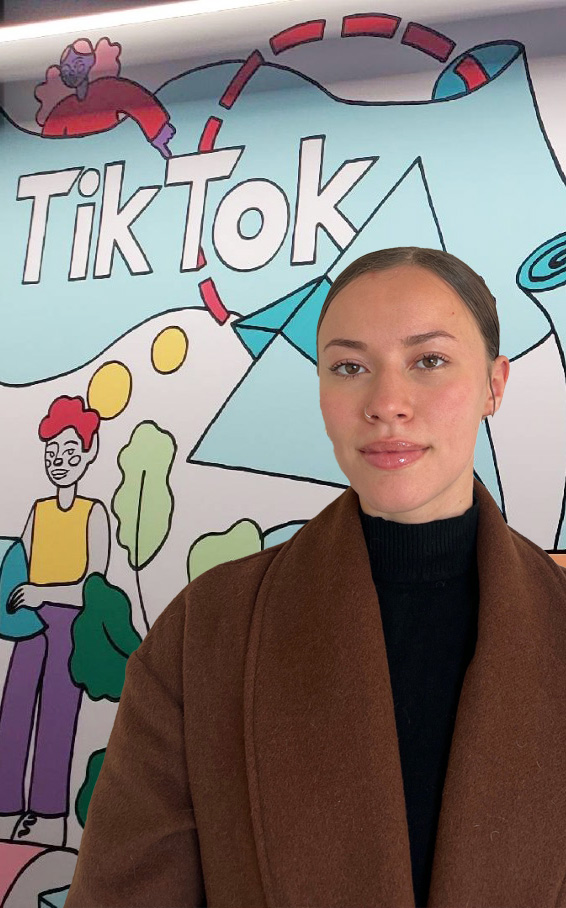 Asia Perez in front of a Tik Tok mural
