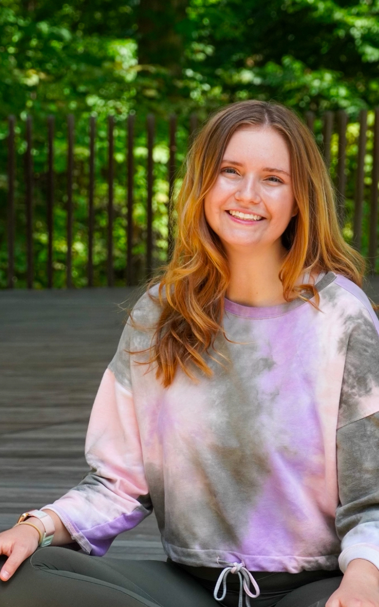 Rachel Beall seated in a yoga pose