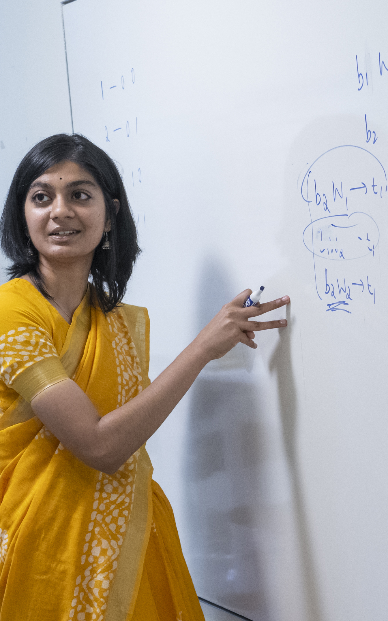 Sneha Dixit '23 discussing equations on a whiteboard