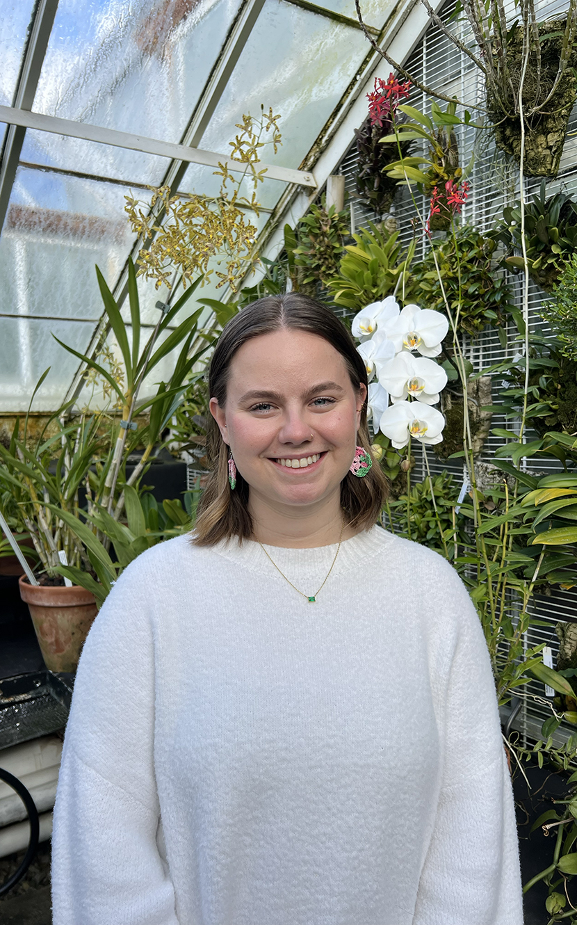 Sydney Voelbel '22 in a greenhouse