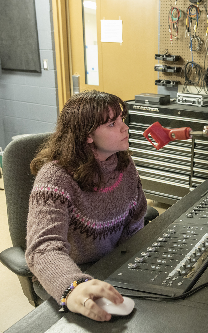 Stevie Lyles at a mixing board in the Department of Music