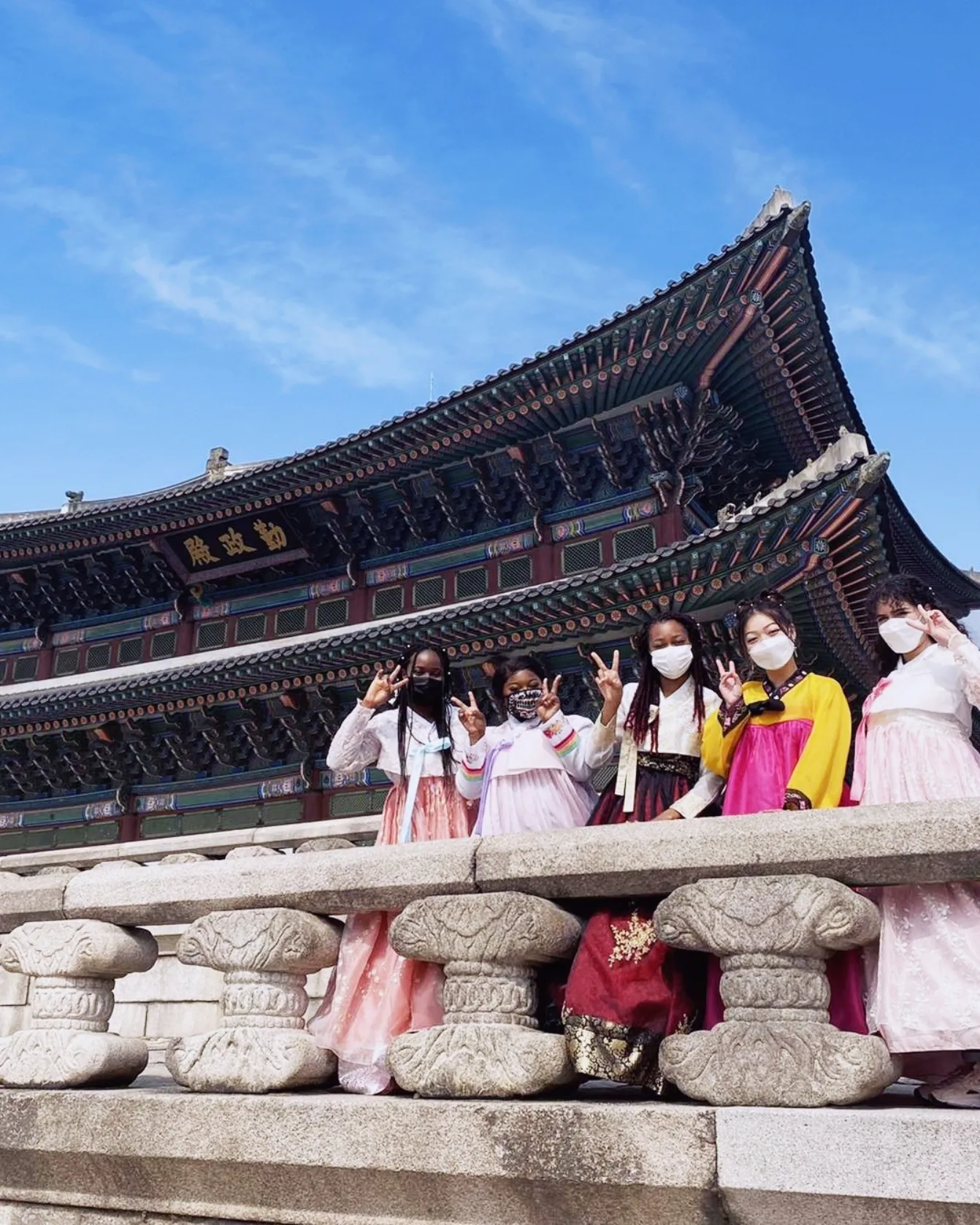 Kelly, in a white hanbok, with four friends in South Korea